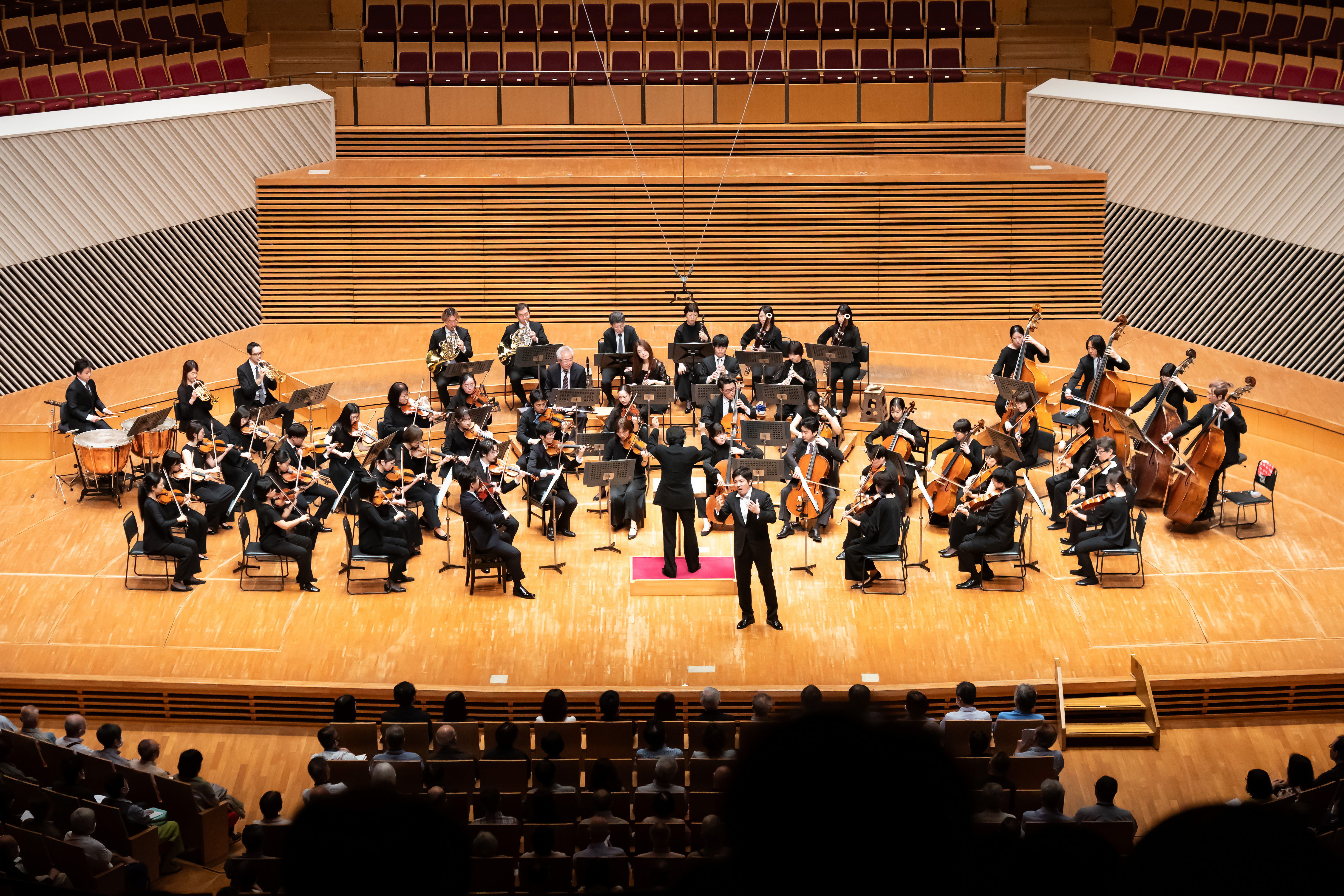 モーツァルト・マチネ第57回の様子。東京交響楽団の前で大西さんが歌っている写真。